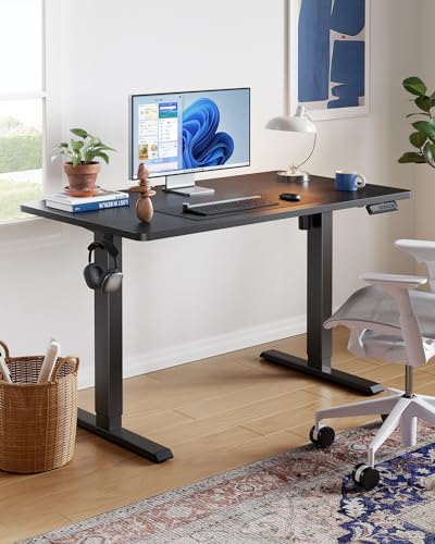 HUANUO electric standing desk in a stylish office with monitor and keyboard setup.