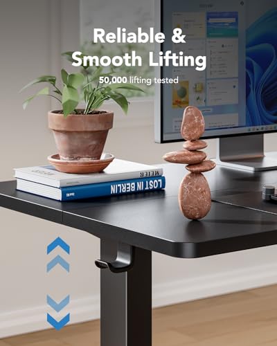 HUANUO electric standing desk showcasing smooth lifting with decorative stones and plants.