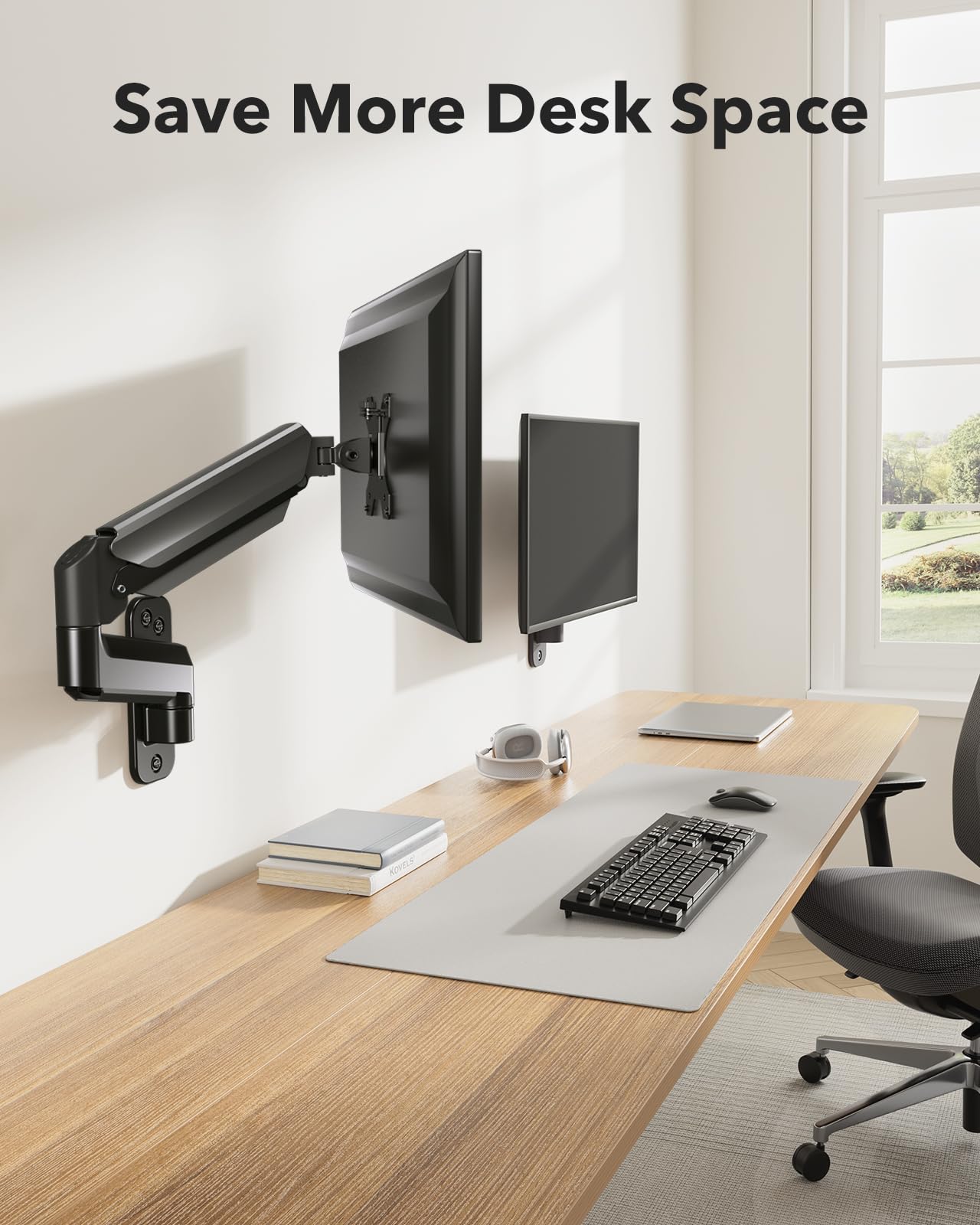 Black gas spring monitor arm maximizing desk space with dual monitors.