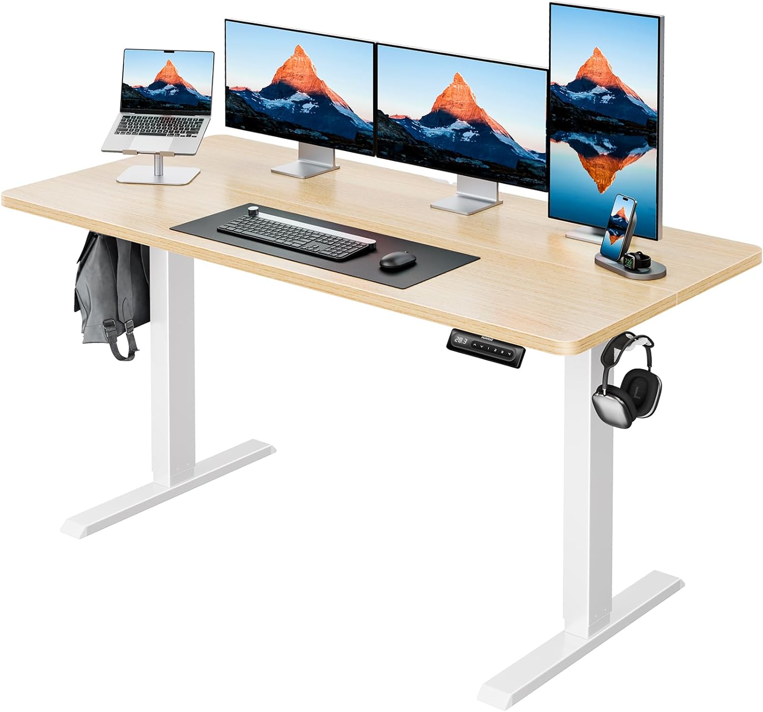 HUANUO standing desk with three monitors, laptop, keyboard, and organized accessories.
