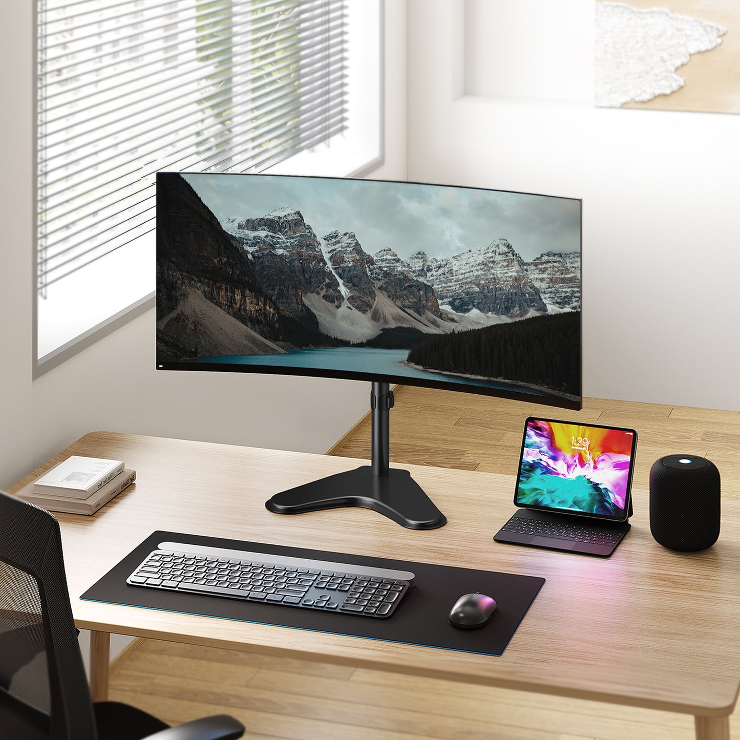 Modern ergonomic desk setup with curved monitor and accessories.