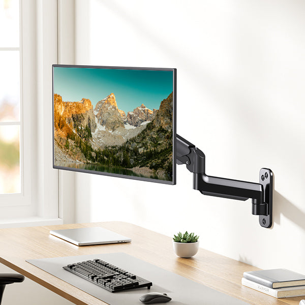Adjustable black gas spring monitor mount with 32-inch screen displaying mountains
