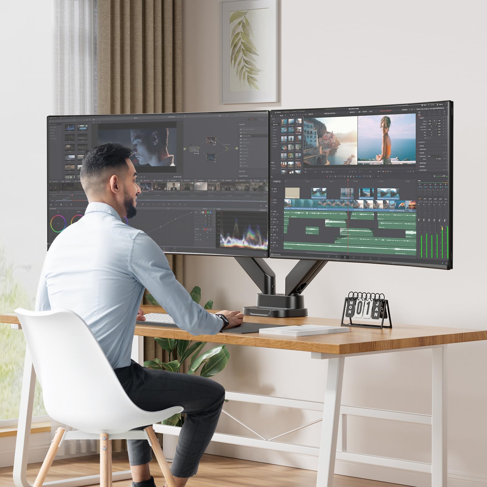 Person using dual monitor setup for video editing on 40-inch screens.