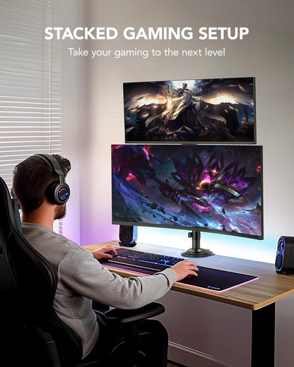 Gaming setup with dual stacked monitors displaying colorful graphics and ambient lighting.