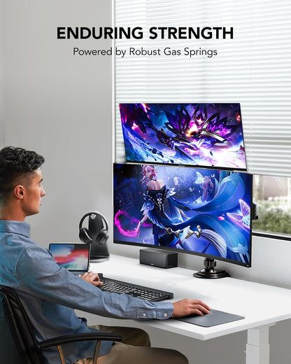 User working at desk with dual monitors showcasing gaming visuals and ergonomic design