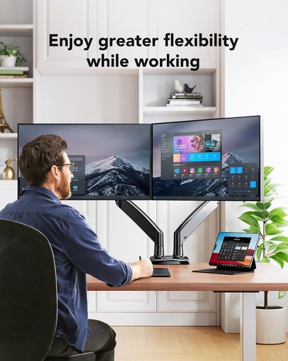 Man using HUANUO dual monitor mount with ultrawide screens for an ergonomic workspace