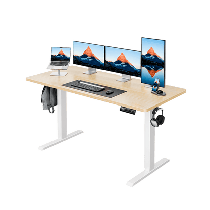 Ergonomic electric standing desk with four monitors, laptop, and keyboard setup.