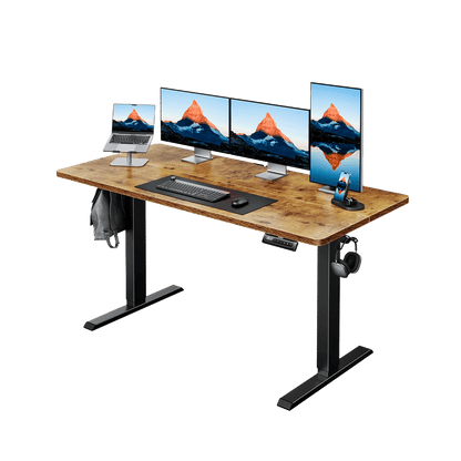 Wooden electric standing desk with four monitors and a laptop setup for ergonomic workspace.