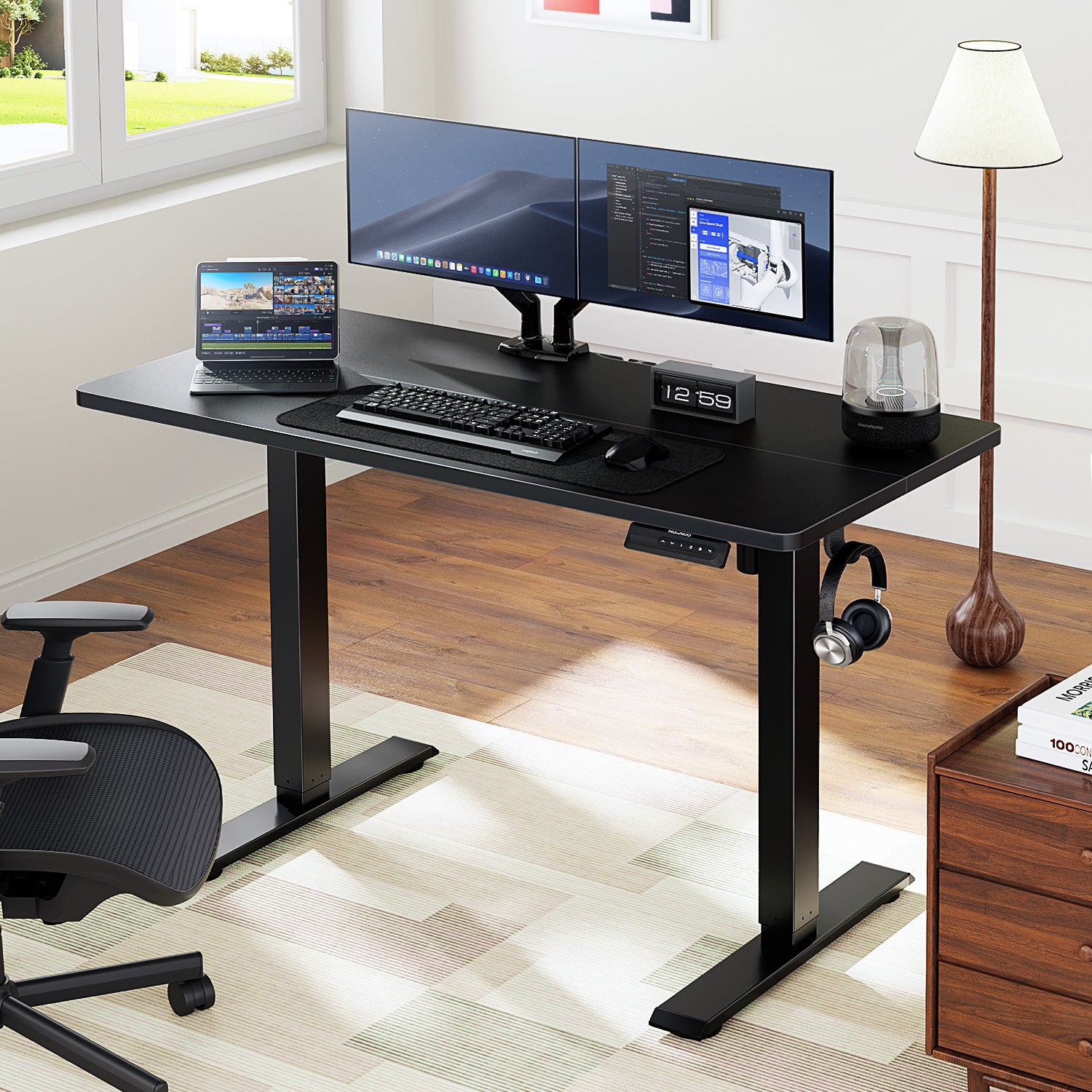 HUANUO electric standing desk featuring dual monitors, laptop, and modern office accessories.