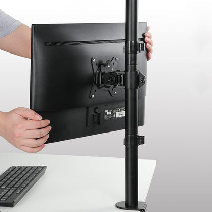 Adjusting vertical dual monitor mount for ergonomic workspace setup.