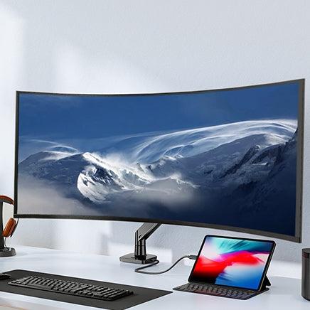 Curved ultrawide monitor mounted on stand in a modern workspace