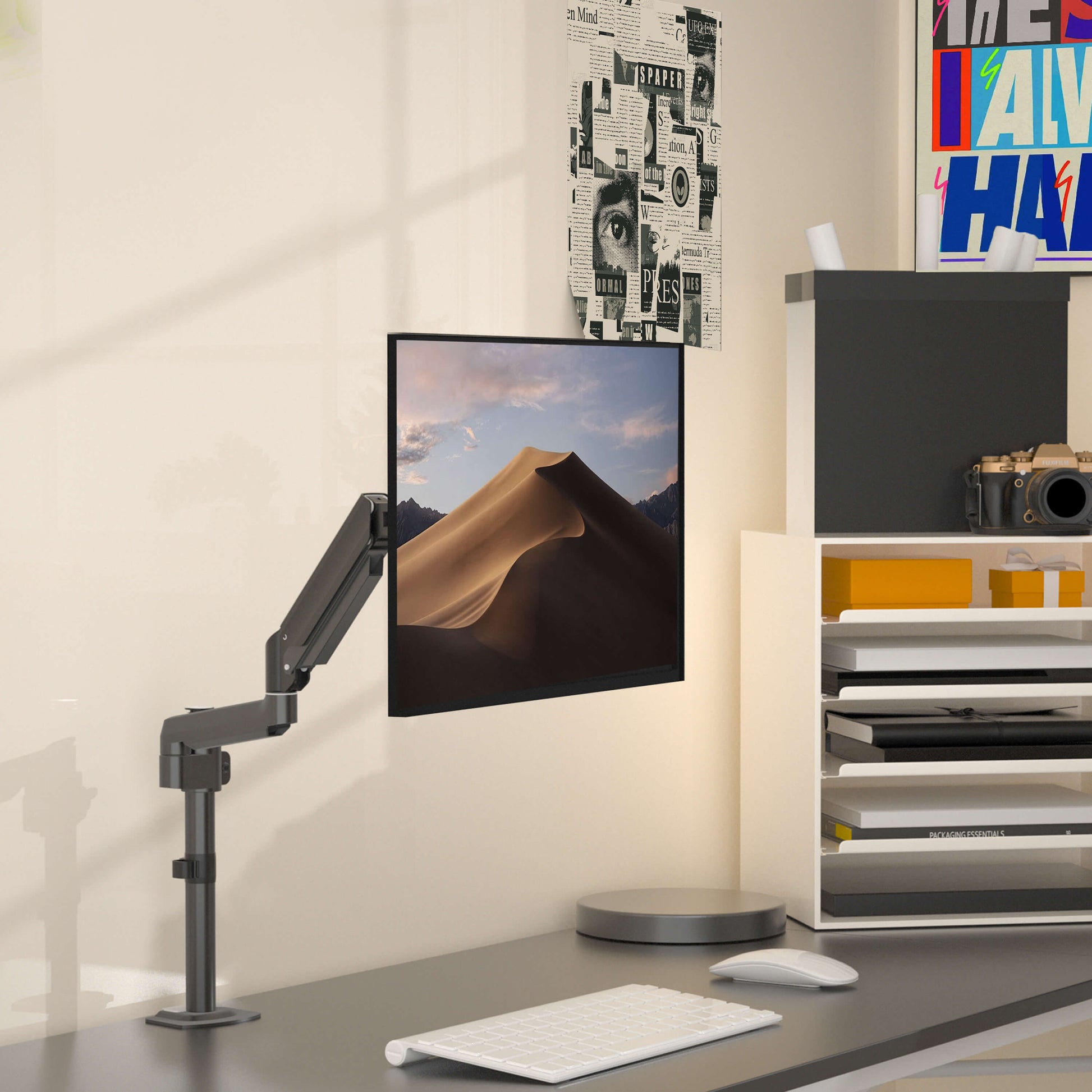 HUANUO single monitor arm elevating a 27-inch display in a modern office setup