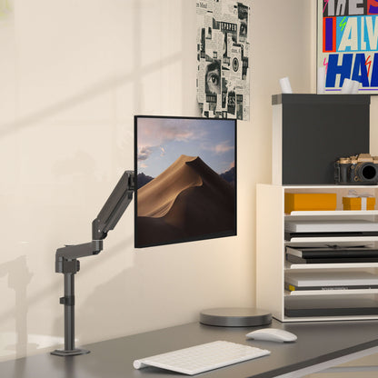 HUANUO single monitor arm elevating a 27-inch display in a modern office setup