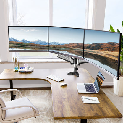 Ergonomic workspace with HUANUO triple monitor stand and three curved screens