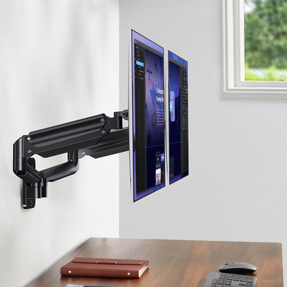 Dual monitor wall arm holding two screens, maximizing desk space in an office setup